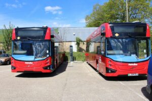 Red Electric Metro Buses being charged at MC Truck and Bus state-of-the-art PDI facility